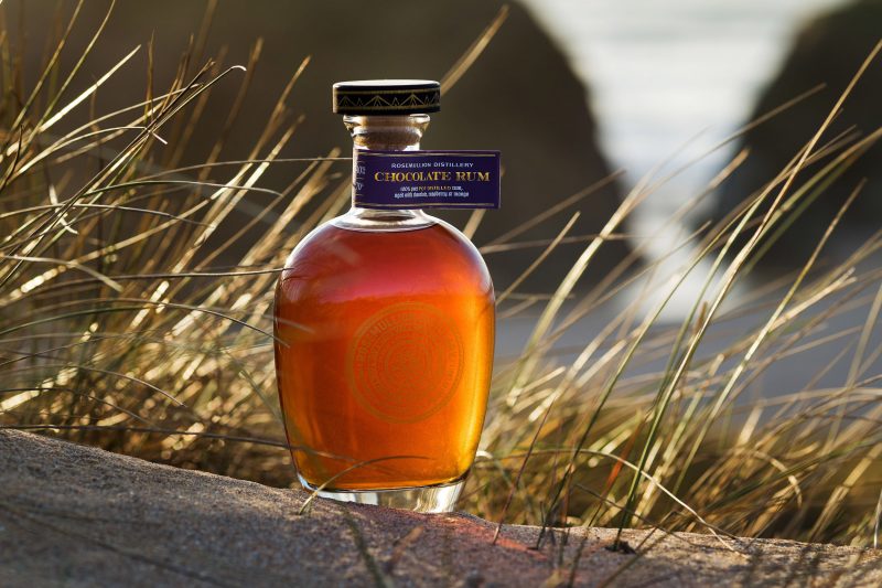 Rum bottle on a cliff above the sea