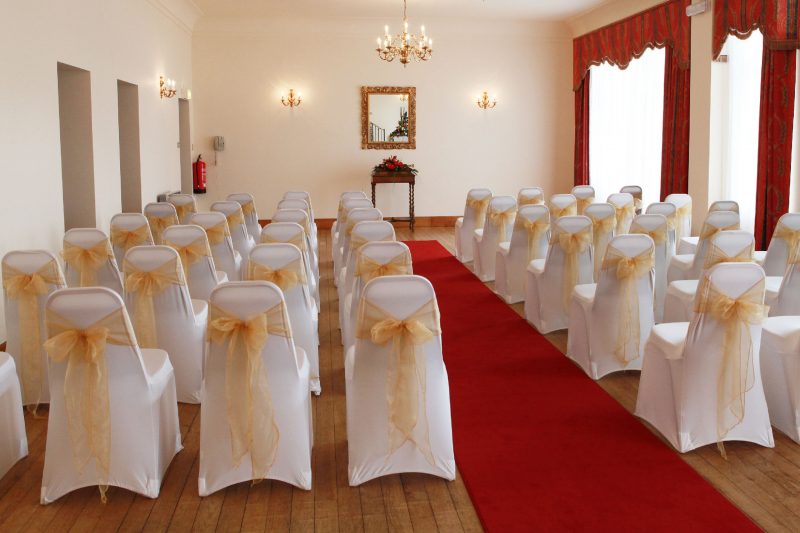 Wedding setup with chairs in a small room.
