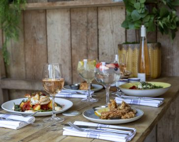 Food and drink on a table in the garden at The Latchmere